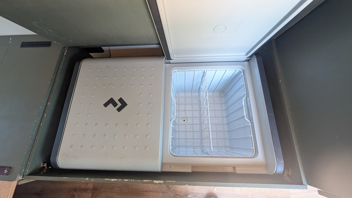  and a convertible bed/table.|Spacious RV rental interior featuring a grey floor with wooden center — photo 3