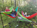 Four girls relax in vibrant hammocks among forest trees, a perfect serene moment for an **RV rental** outdoor trip.