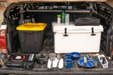 RV rental ready! Truck bed packed with camp kitchen setup, including stove, cooler, and cooking essentials for adventures.