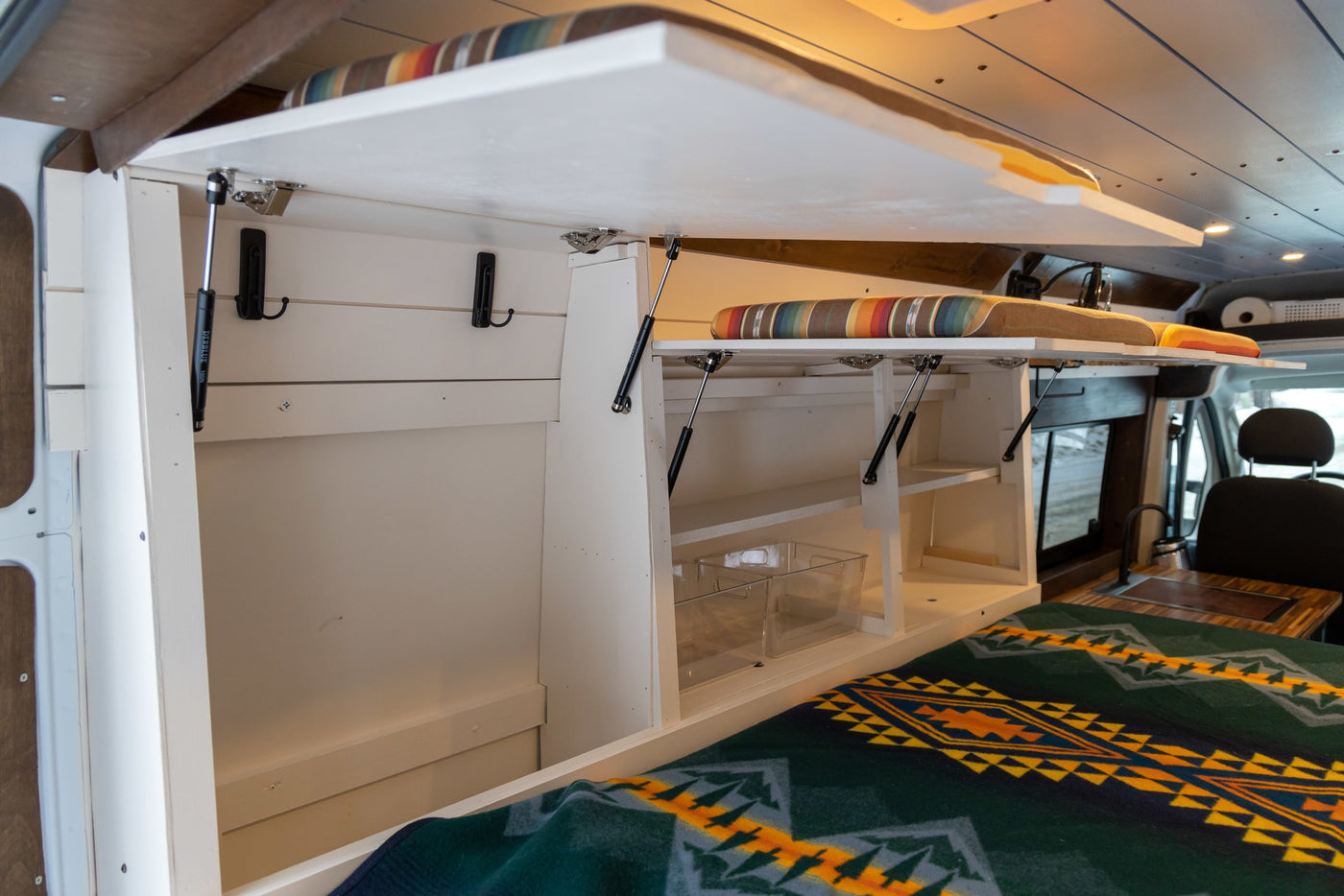  and bright yellow storage.|Cozy RV rental interior with custom wood art of mountains & bison — photo 15