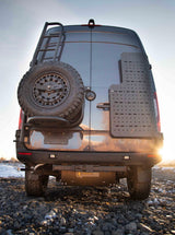 Rear view of a customized Mercedes-Benz Sprinter RV rental, featuring an off-road tire, ladder, rear gear panel, and generator.