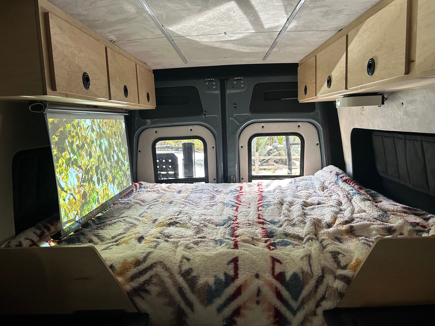  surrounded by vibrant golden fall aspens and rocky peaks.|A cozy RV rental bed offers stunning ocean — photo 5