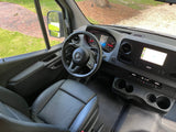 RV rental interior: driver's view of the modern dashboard, steering wheel, and comfortable seat, ready for the road.