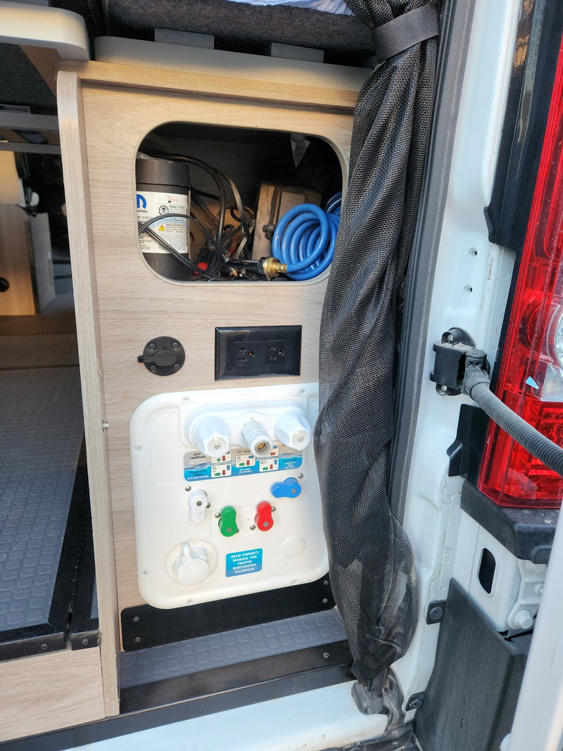  and controls for comfy travel.|Inside an RV rental pop-top camper: plastic-covered bed — photo 17