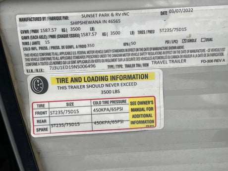 RV rental trailer info label shows VIN, tire size ST235/75D15, cold pressure 65PSI, and 3500 lbs load capacity.