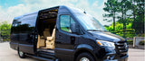 Black Mercedes-Benz Sprinter luxury van, side door open revealing light interior. Ideal for RV rental and comfortable travel.