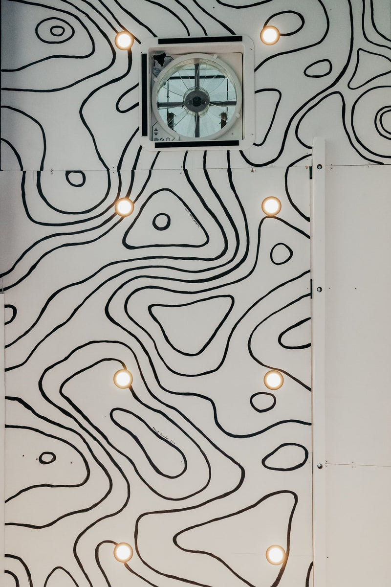  and Dometic fridge.|Custom RV rental interior featuring an adjustable wooden table — photo 12