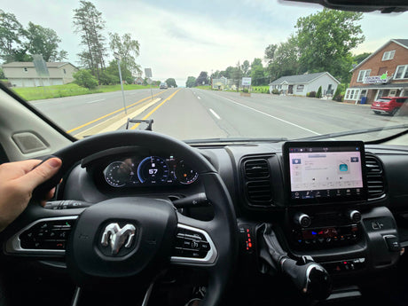  parked on asphalt with trees in background.|Modern rv rental interior: dark wood cabinetry