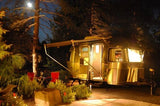 Cozy Airstream travel trailer rental illuminated at night, perfect for a relaxing RV vacation getaway.