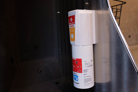A First Alert KITCHEN5 dry chemical fire extinguisher, crucial for fire safety in an RV rental kitchen or similar small space.