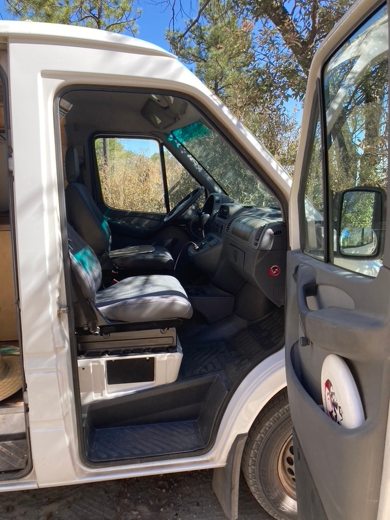  and a decorative privacy curtain.|This RV rental shows a camper van interior with custom storage — photo 9