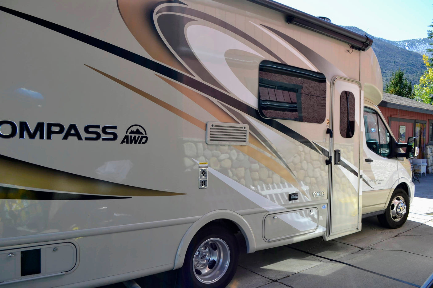This beige Compass AWD RV rental is ideal for exploring scenic mountain areas and enjoying outdoor travel.