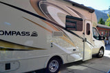 This beige Compass AWD RV rental is ideal for exploring scenic mountain areas and enjoying outdoor travel.