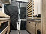 Inside a modern RV rental, featuring a foldable bed, rear mesh screens, and smart storage solutions for comfortable travel.