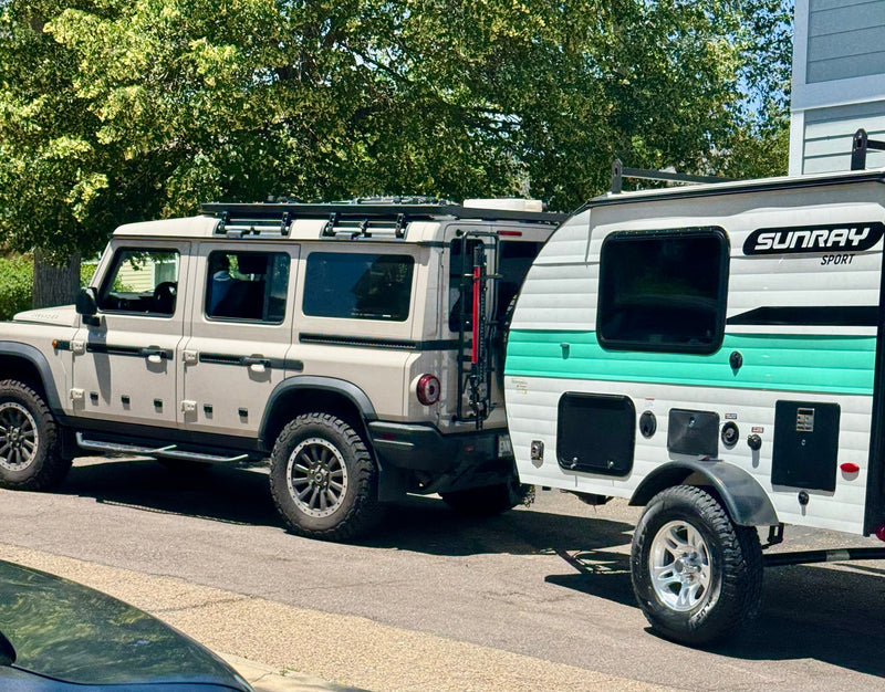 Ineos Grenadier SUV towing a Sunray Sport RV rental for camping trips. Ready for adventure on the road. — photo 13