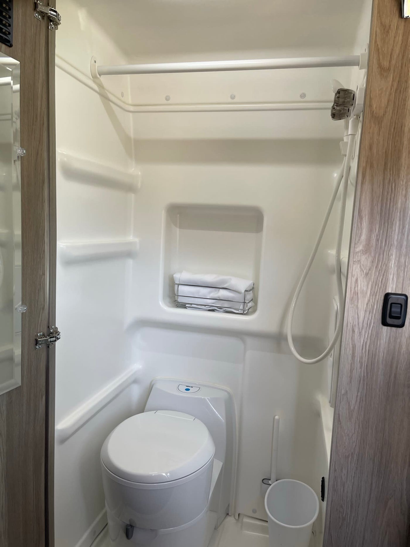  plus a comfortable bed overlooking a serene river.|Cozy and modern rv rental interior featuring comfortable seating — photo 9