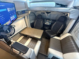 RV rental interior: front cockpit, dining table, plush seating, and Roku TV. Ready for adventure and relaxation.