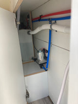 Compact RV rental water system: showing pump, tank, and neatly routed PEX plumbing. Practical setup for adventurers.
