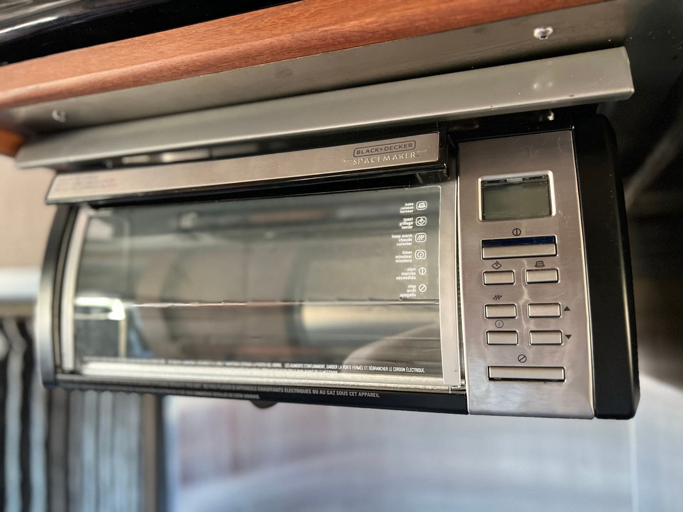  and wooden cabinets. Ready for your road trip adventures.|Explore this RV rental's compact kitchen area: microwave — photo 7