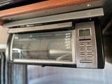 Compact Black+Decker Spacemaker toaster oven, under-cabinet mounted, ideal for an RV rental kitchen.