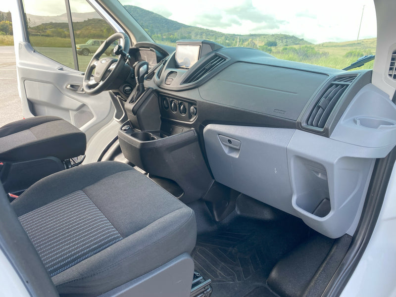 RV rental: View of a van's clean front cabin. Shows driver's controls, dashboard, and two front seats. — photo 9