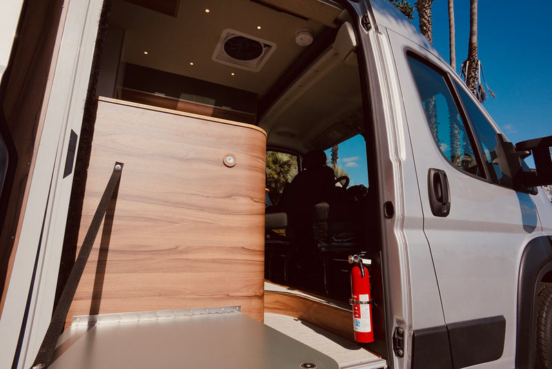  and warm wood accents.|Inside a stylish RV rental: a modern kitchen with induction cooktop — photo 11