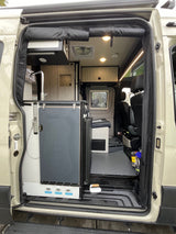 Explore this modern camper van's interior for your next RV rental, featuring a compact kitchen, living area, and bright lighting.