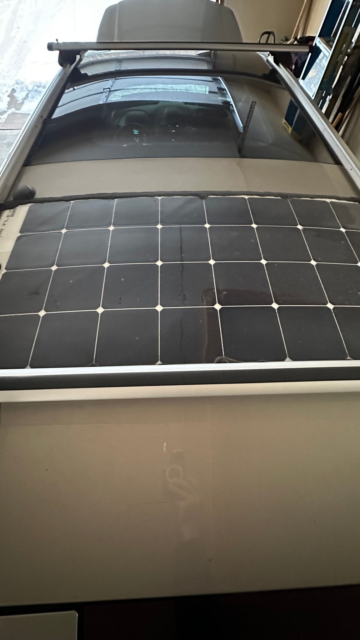 Top-down view of an RV rental roof featuring flexible solar panels and a roof rack system, ideal for off-grid power. — photo 9