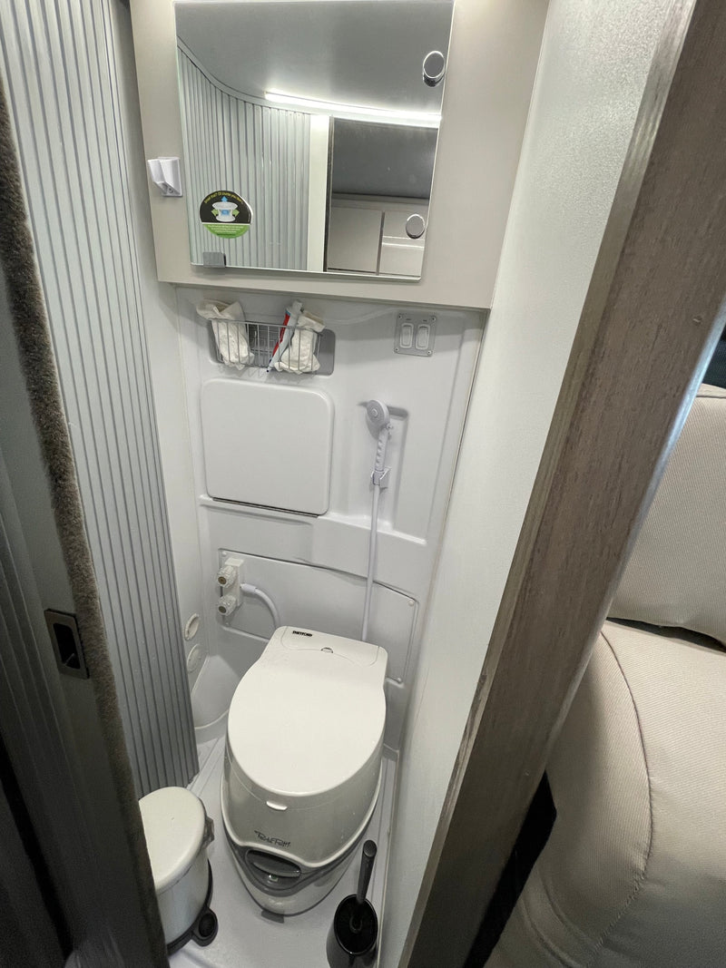  and bright ambient lighting.|Modern RV rental kitchen shows sink — photo 10