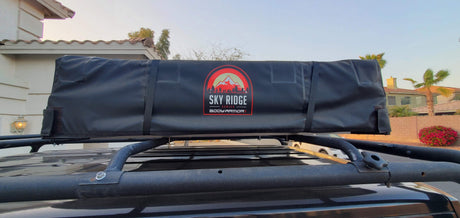 Sky Ridge rooftop tent on vehicle roof rack, perfect for an rv rental-like outdoor adventure.