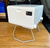 White portable mini-washing machine with a control panel and stand, ideal for laundry in an RV rental or camping.