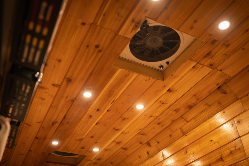  and basket storage.|Stylish wood-paneled van conversion rv rental interior with cozy bed — photo 20
