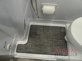 Compact RV rental wet bath interior with shower hose, toilet, and custom-fit gray floor mat.