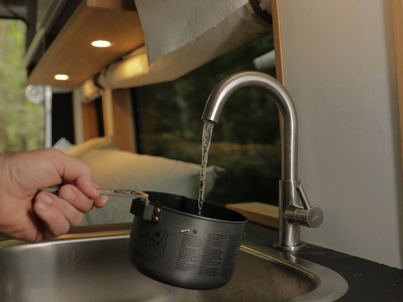  storage. Enjoy forest views with feet up in this cozy mobile home.|Relax in this RV rental van: cozy bed — photo 5