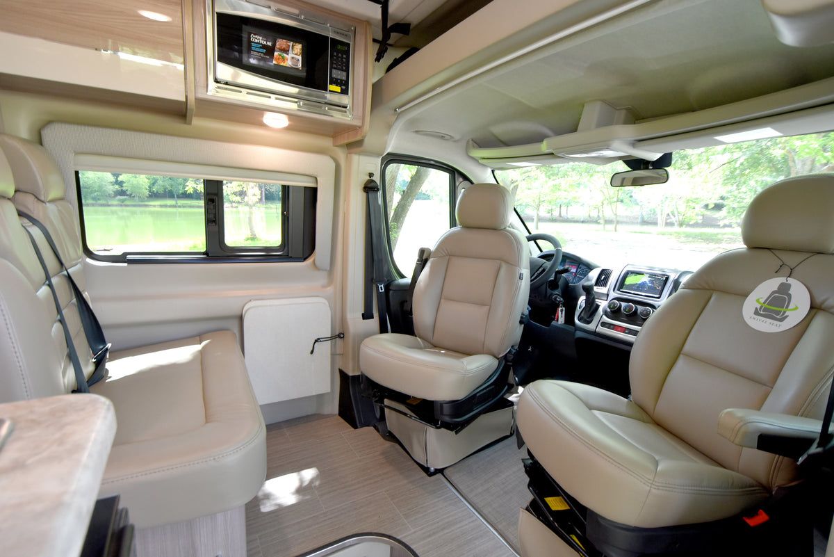 Explore this modern rv rental interior: swiveling front seats, microwave, and scenic lake view from the living area. — photo 2
