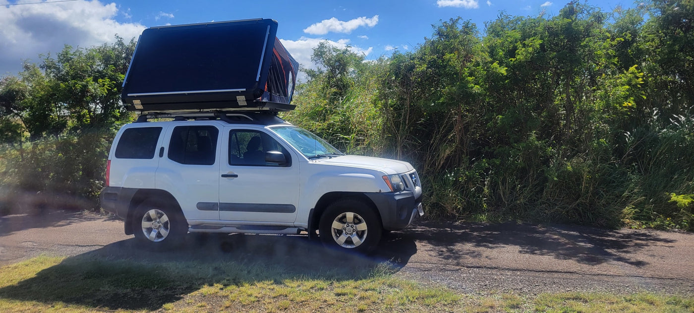 White Nissan Xterra with rooftop tent, ready for adventure camping. Discover unique RV rental options for your next trip. — photo 18