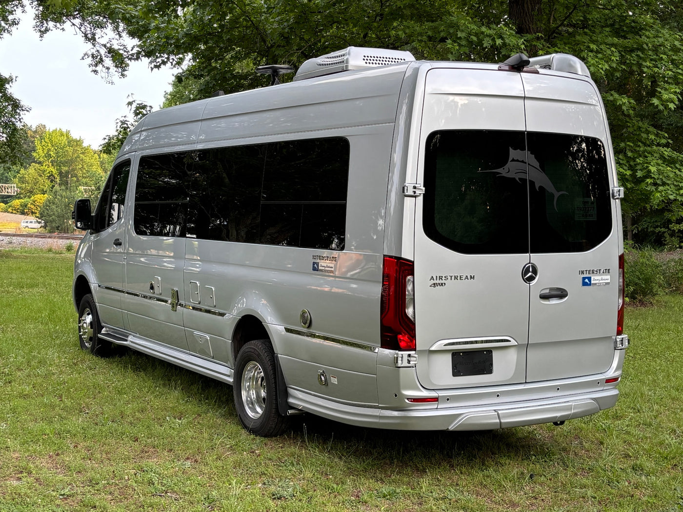  and bright cockpit ahead.|Silver Airstream Mercedes-Benz Sprinter RV rental parked on a lush green lawn — photo 8