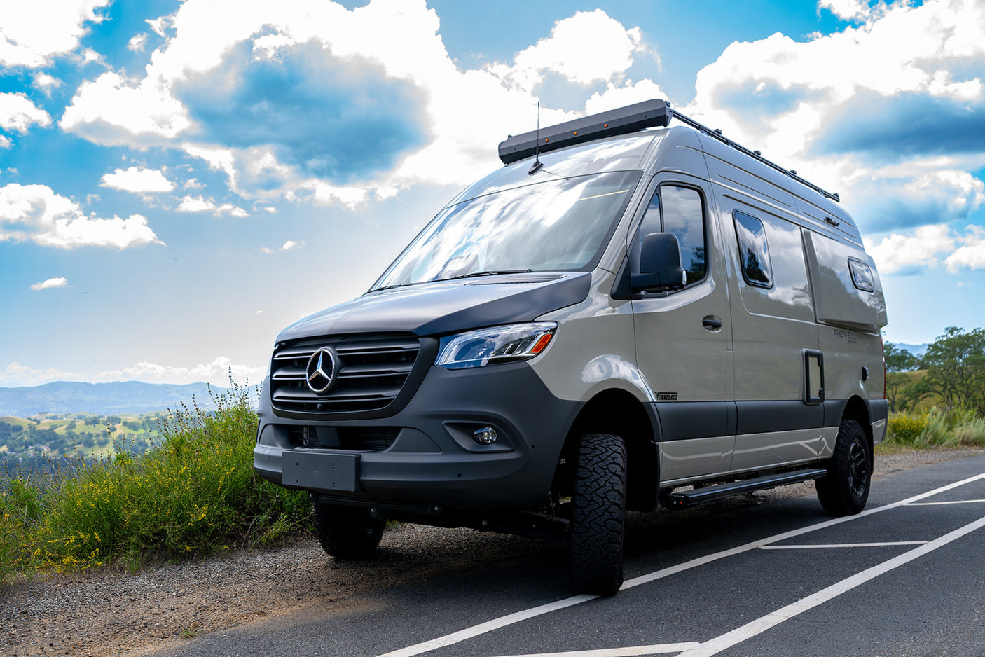 Stylish Mercedes Sprinter RV rental. This Winnebago Revel camper van with off-road tires is perfect for exploring scenic routes.