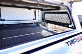 View inside an off-road truck camper, featuring a carpeted floor and a mesh window. Great for rv rental.