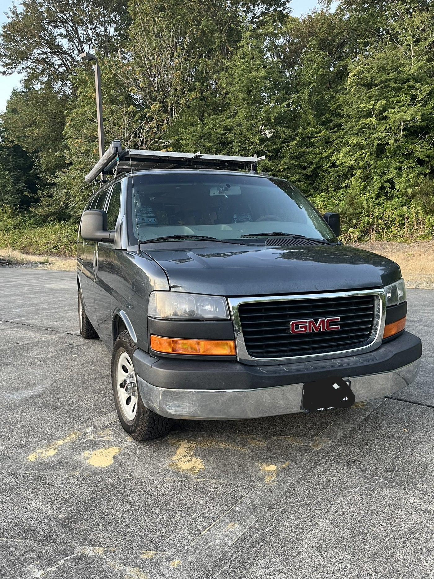 Gray GMC camper van with rooftop solar and awning, perfect for your next RV rental adventure! — photo 13