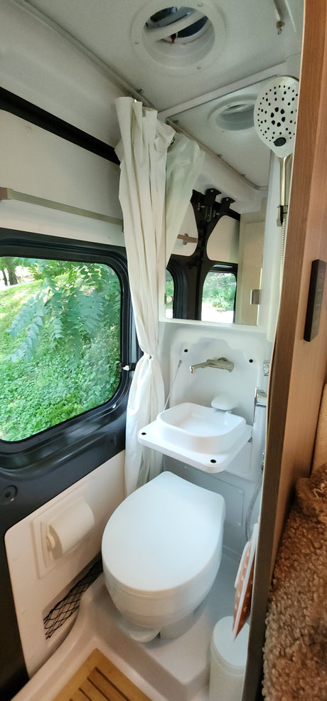 RV rental bathroom: compact design with toilet, foldable sink,