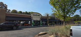 A vibrant commercial strip with 'Back b Nine' indoor golf & 'Elevate' chiropractic. A great stop after an RV rental adventure!