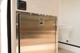 Explore this RV rental's interior: a sleek stainless steel fridge, power awning controls, and a glimpse of the compact bathroom.