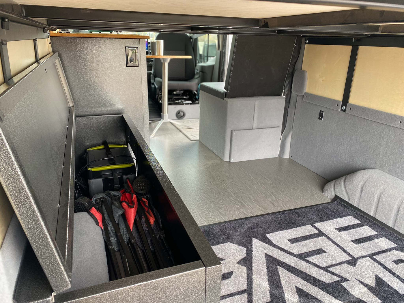  plus gray floor and seating.|RV rental interior: storage box — photo 13