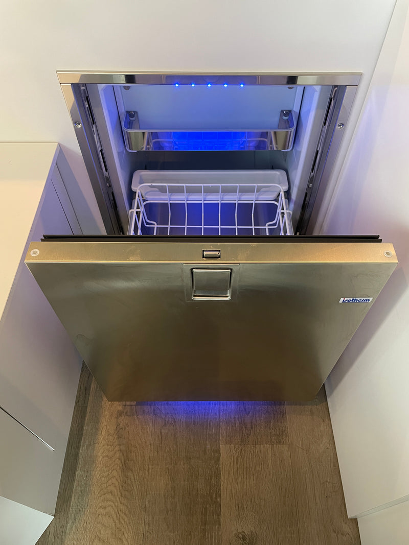 Opened Isotherm stainless steel drawer fridge/freezer with blue lighting, a space-saving appliance in this RV rental. — photo 7