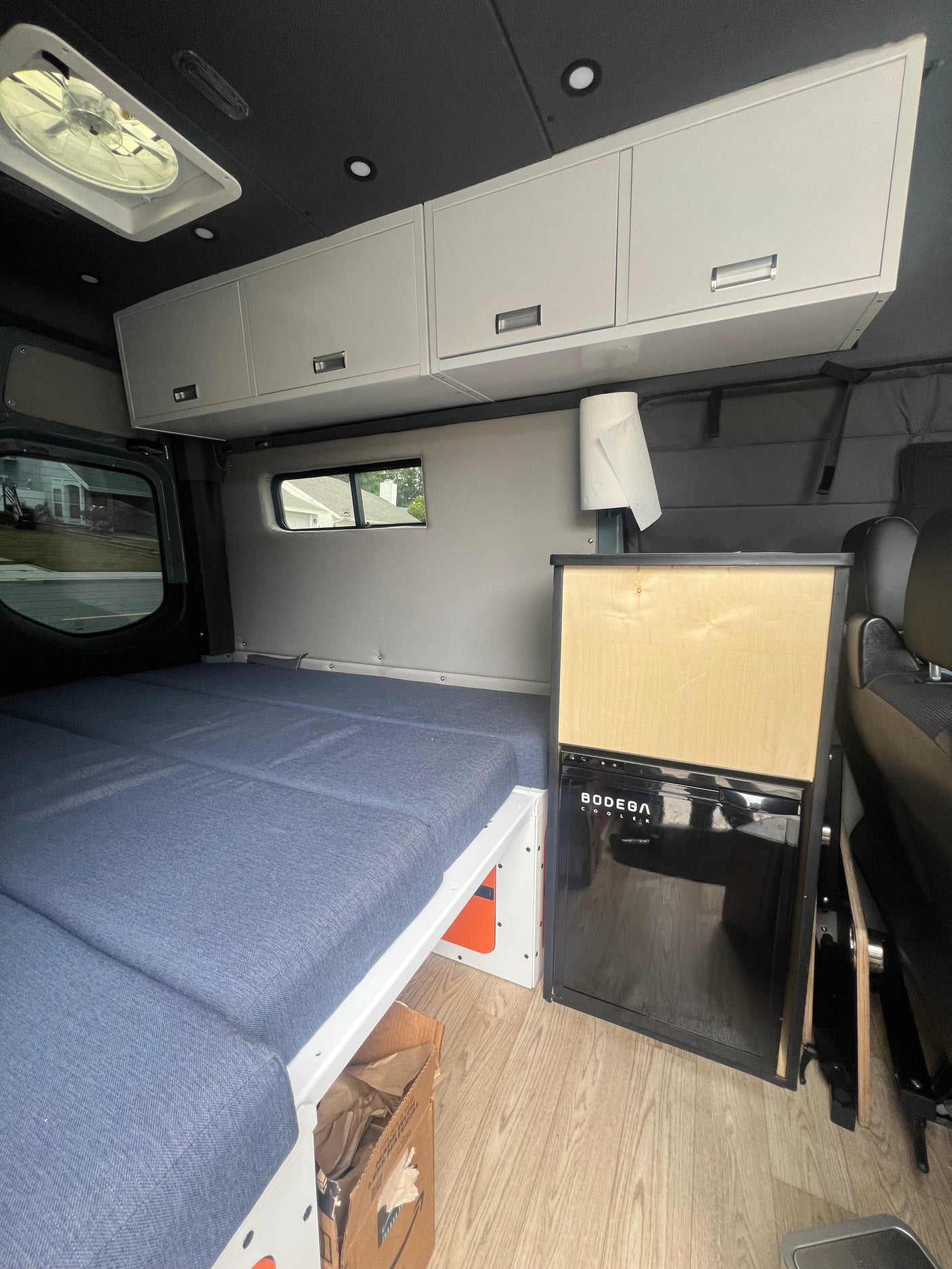 Step inside this cozy RV rental! Features a modular bed, sleek cabinets, and a BODEGA cooler, ready for your road trip.