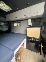 Step inside this cozy RV rental! Features a modular bed, sleek cabinets, and a BODEGA cooler, ready for your road trip.