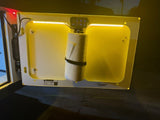 RV rental: Illuminated compartment door with essential paper towels & control panel for easy access on your trip.