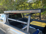 Truck equipped with 'From Bed Rack' and a 'BA Tents' rooftop tent, an ideal RV rental alternative for your overland adventure.