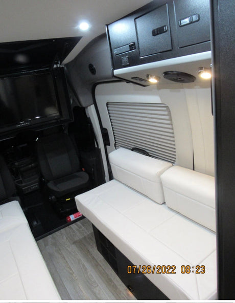  displayed in a brightly lit facility.|Inside an rv rental: View looking forward showing a compact kitchen (left)
